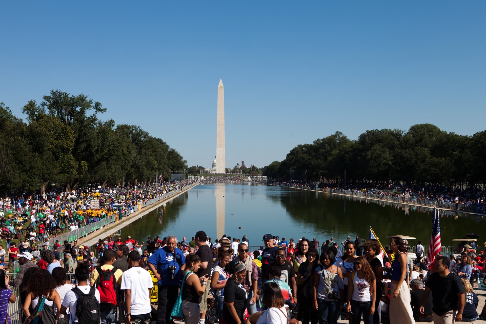 Washington Monument with reflecting pool and crowd - representing civic engagement